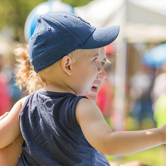 A little boy being carried by his mom during Ice Cream Days in Le Mars.