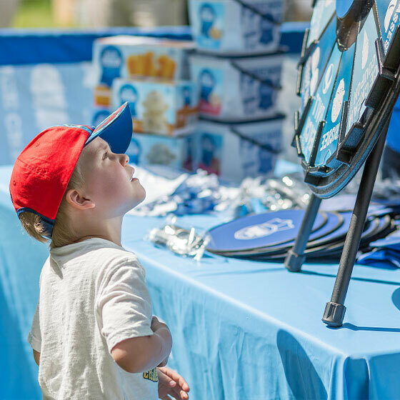 A little boy looking up at the Blue Ribbon Classics prize wheel during Ice Cream Days in Le Mars.