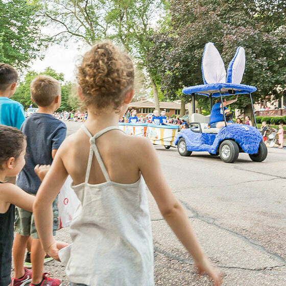 A little girl watching the Blue Bunny parade float during the Ice Cream Days in Le Mars.