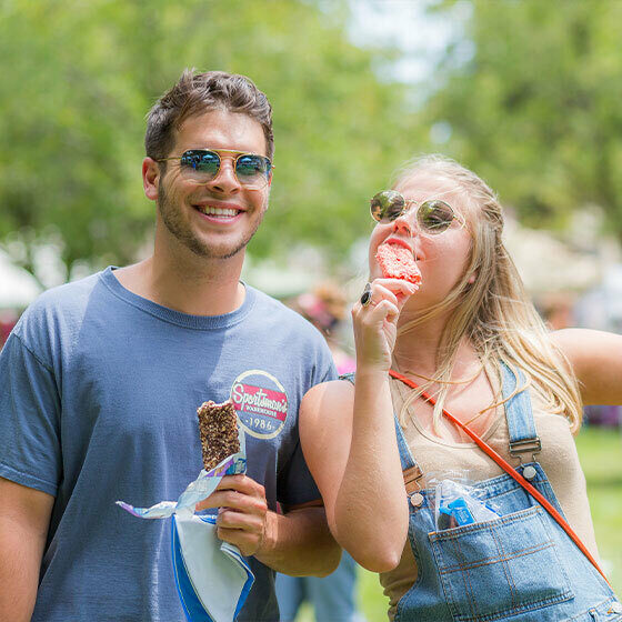 A couple enjoying ice cream and smiling at the camera during Ice Cream Days in Le Mars.